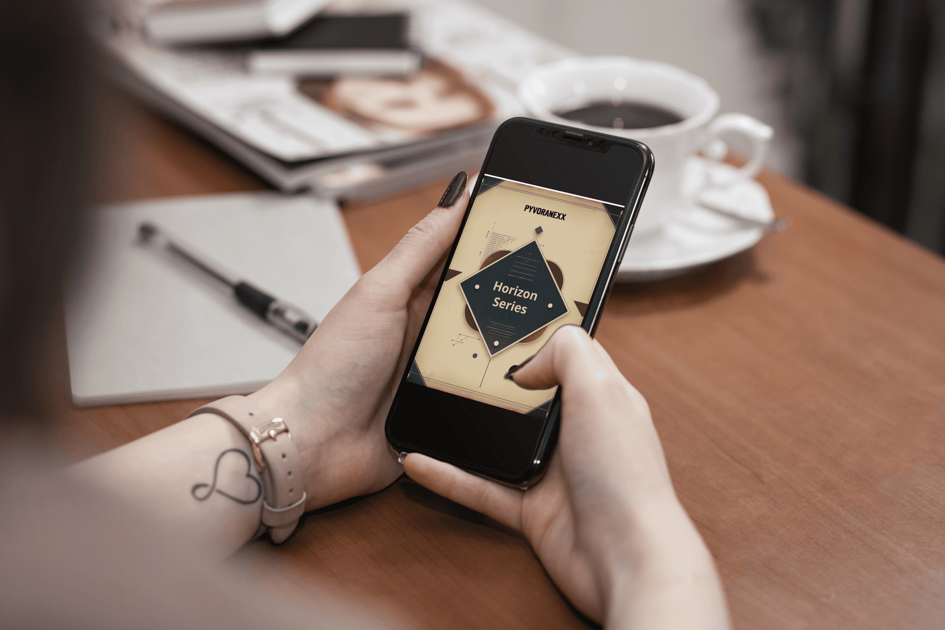 Person holding a smartphone with a Python course on a table with a cup of coffee and a magazine.